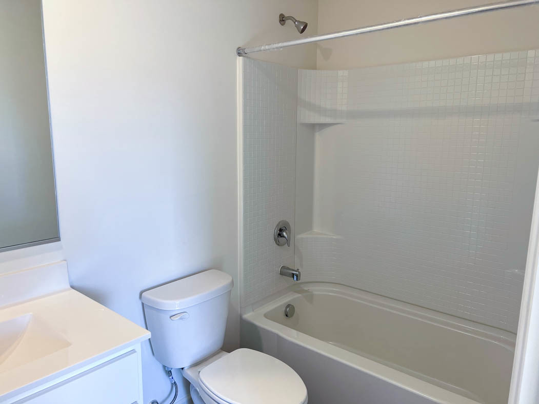 6740 Linden Trail, Unit D Wonder Lake, IL 60097 - Photo 9 of 55 a white toilet and tub sitting next to a bathroom sink