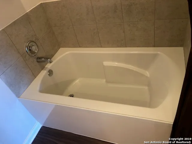 a bathroom with a toilet a sink and bathtub