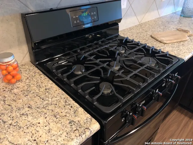 a kitchen with a sink and a stove top oven