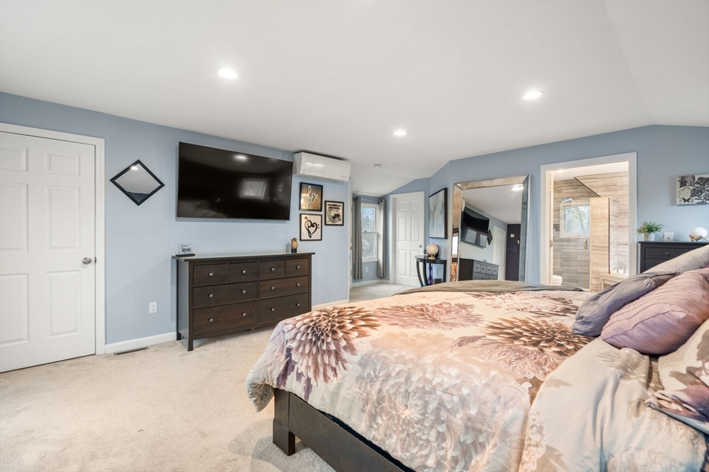 2 Taylor Road Yarmouth, MA 02664 - Photo 15 of 34 a spacious bedroom with a bed and a flat screen tv