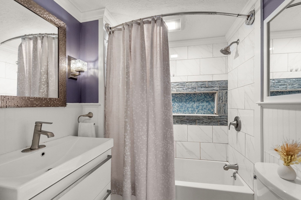 2 Taylor Road Yarmouth, MA 02664 - Photo 23 of 34 a bathroom with a shower a sink and a mirror