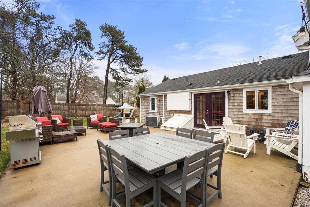 2 Taylor Road Yarmouth, MA 02664 - Photo 31 of 34 a view of a patio with table and chairs and a barbeque