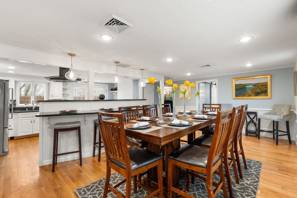 2 Taylor Road Yarmouth, MA 02664 - Photo 5 of 34 a dining table with stainless steel appliances kitchen island granite countertop a dining table and chairs with wooden floor