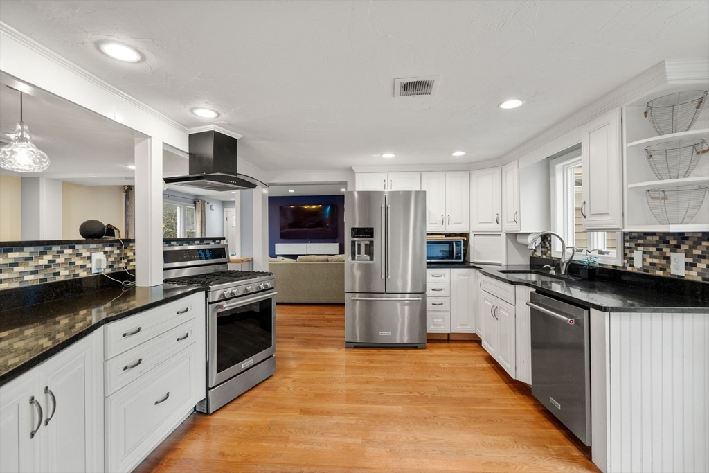 2 Taylor Road Yarmouth, MA 02664 - Photo 6 of 34 a kitchen with stainless steel appliances kitchen island granite countertop a refrigerator and a sink