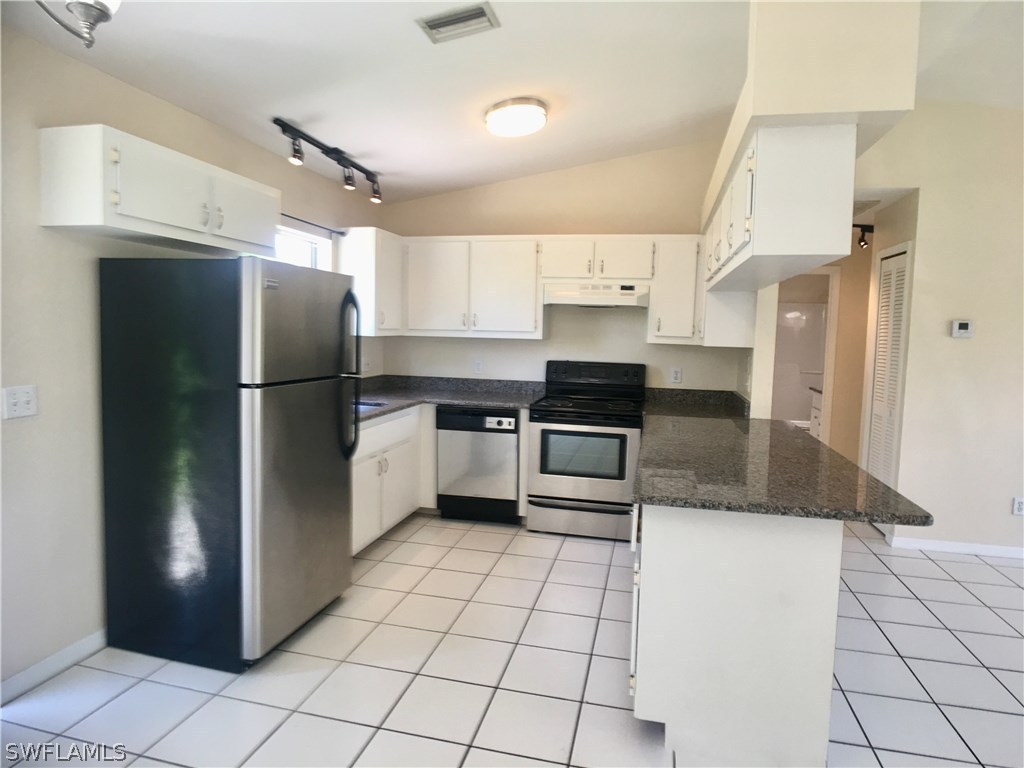 18536 Sebring Road Fort Myers, FL 33967 - Photo 1 of 11 a kitchen with granite countertop a refrigerator and a sink