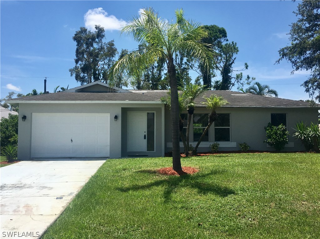 18536 Sebring Road Fort Myers, FL 33967 - Photo 4 of 11 a view of a house with a yard and potted plants