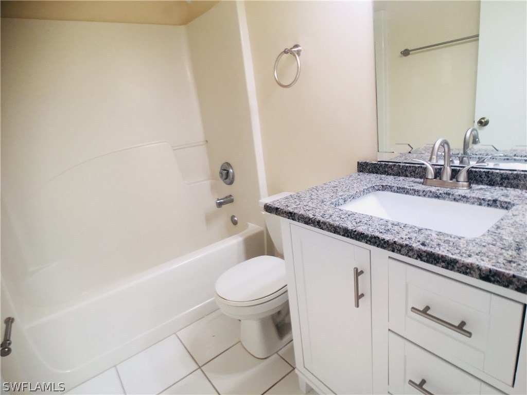 18536 Sebring Road Fort Myers, FL 33967 - Photo 5 of 11 a bathroom with a granite countertop sink toilet and shower