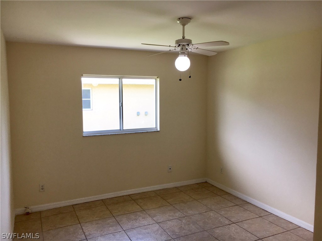 18536 Sebring Road Fort Myers, FL 33967 - Photo 6 of 11 an empty room with a window