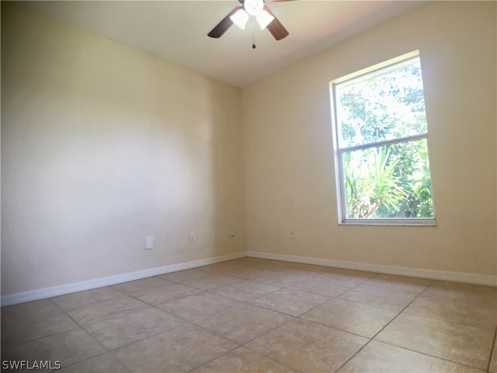 18536 Sebring Road Fort Myers, FL 33967 - Photo 8 of 11 an empty room with a window