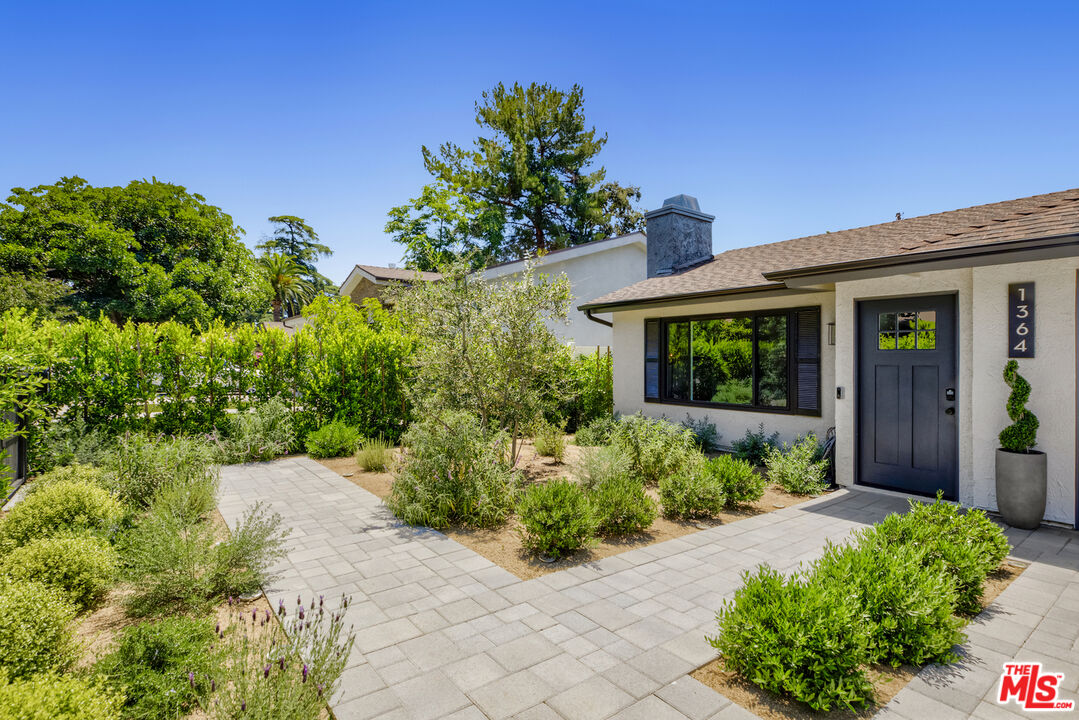 1364 East Woodbury Road Pasadena, CA 91104 - Photo 1 of 50 a front view of a house with a yard