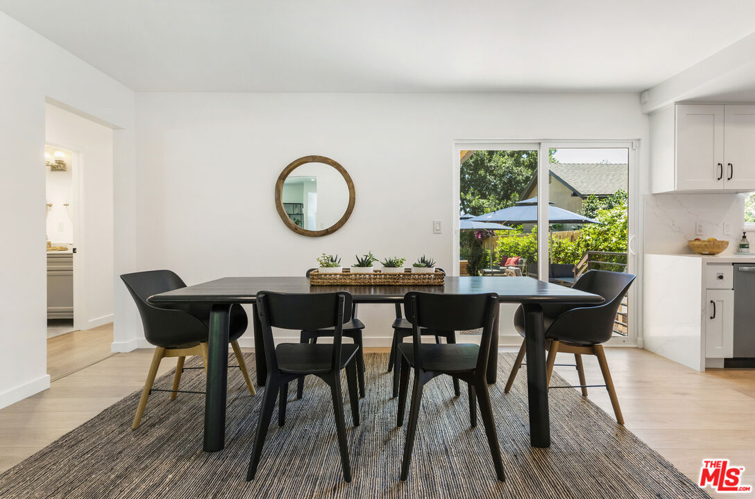 1364 East Woodbury Road Pasadena, CA 91104 - Photo 14 of 50 a view of a dining room with furniture and wooden floor