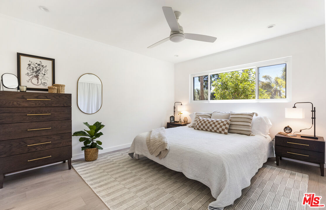1364 East Woodbury Road Pasadena, CA 91104 - Photo 25 of 50 a bedroom with a bed a mirror and a potted plant