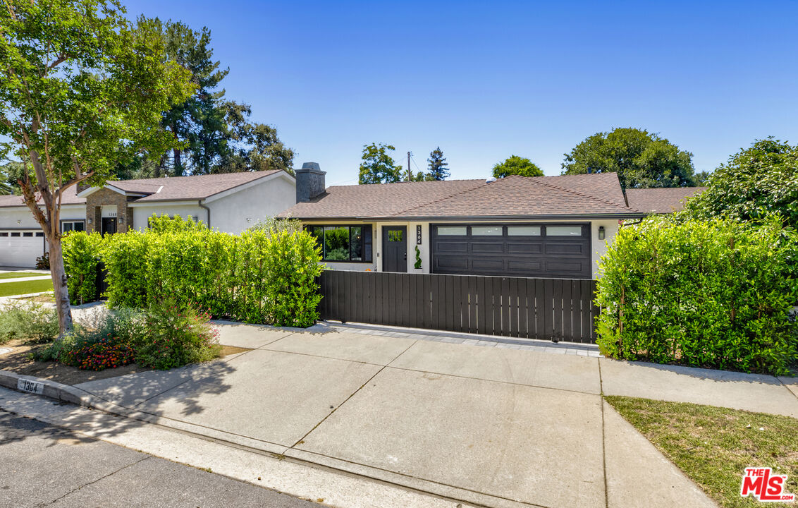 1364 East Woodbury Road Pasadena, CA 91104 - Photo 3 of 50 a front view of a house with a garden