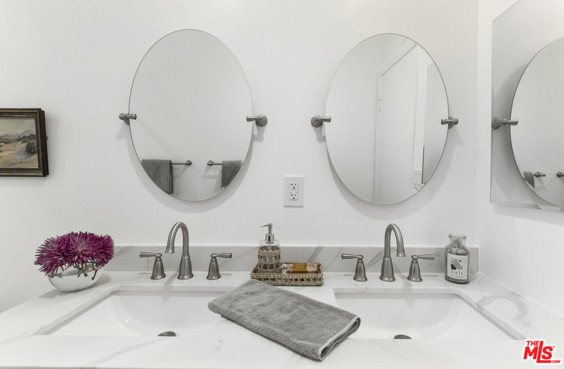 1364 East Woodbury Road Pasadena, CA 91104 - Photo 33 of 50 a bathroom with a double vanity sink and a mirror