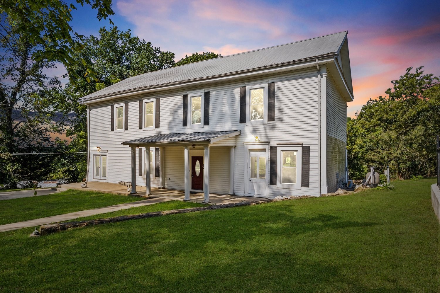 a front view of a house with a garden