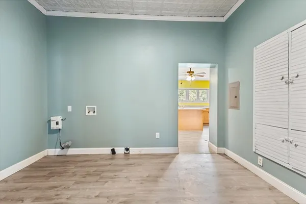 a utility room with stainless steel appliances granite countertop a sink and dishwasher
