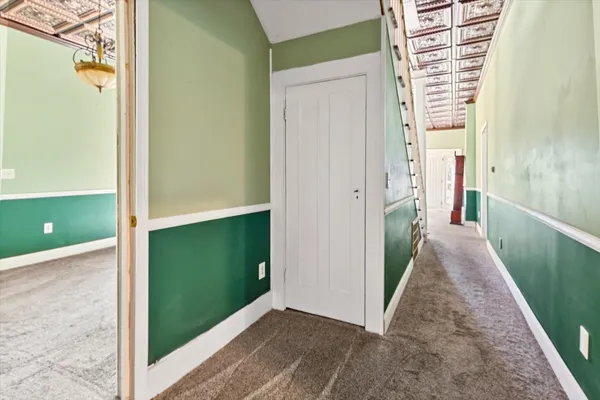 a living room with furniture a chandelier and a dining table