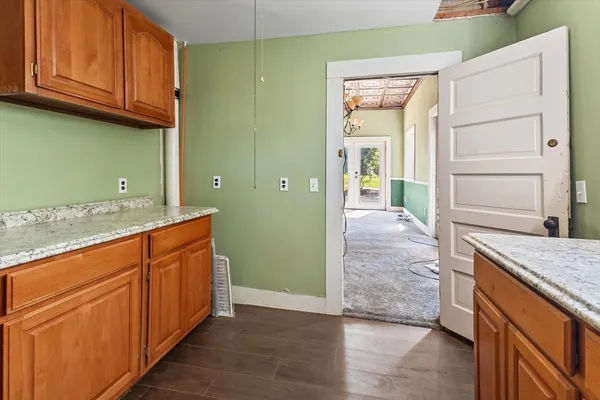 a bathroom with a granite countertop sink and a bathtub