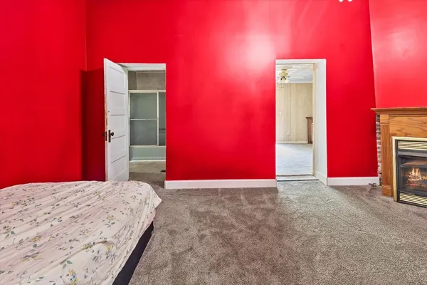 an empty room with a window and wooden floor