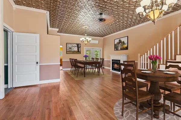 an empty room with wooden floor and fireplace