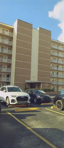 a view of building with car parked