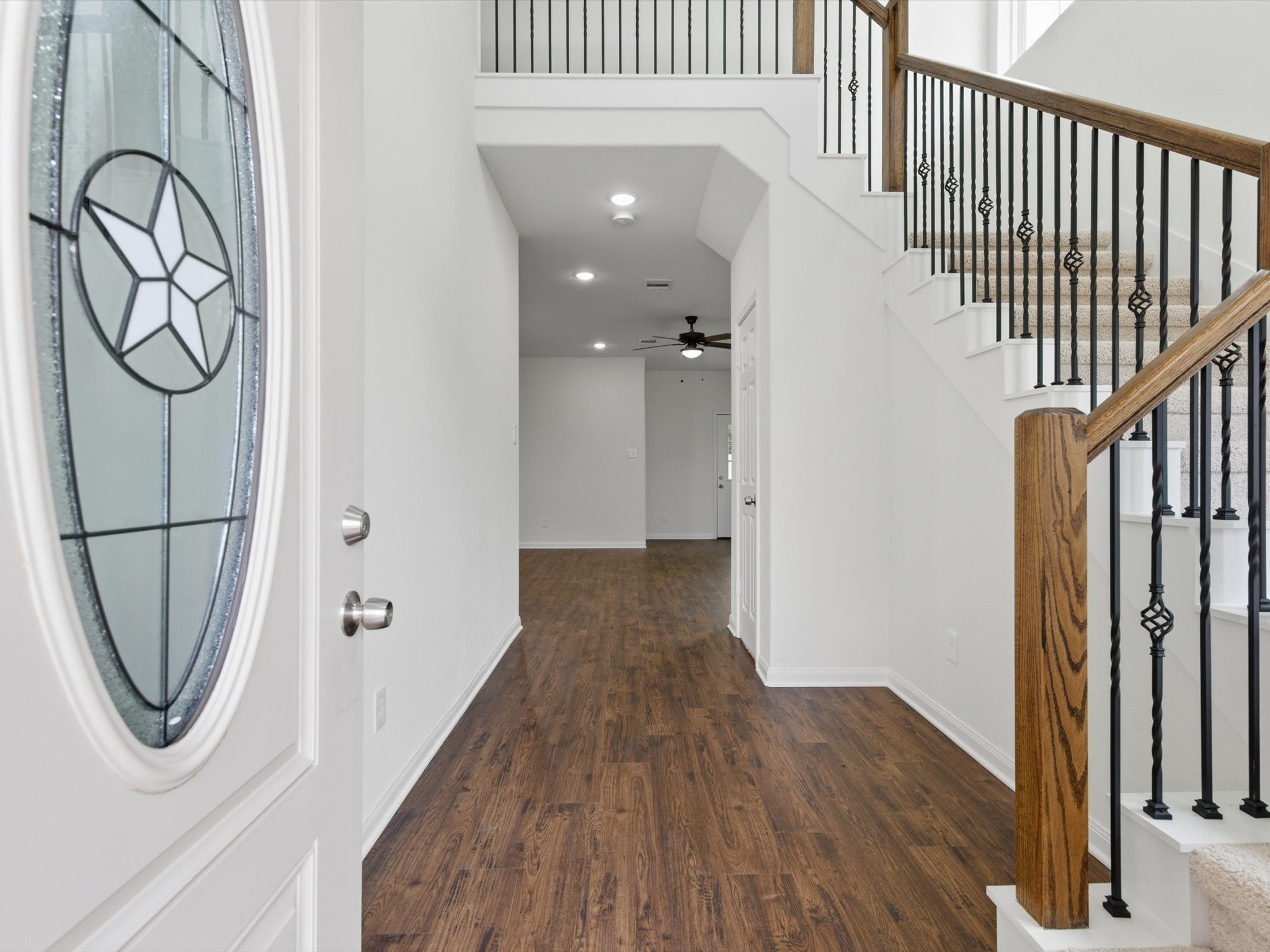 2803 Topiary Lane Houston, TX 77014 - Photo 7 of 31 Step inside to soaring ceilings and sleek vinyl plank flooring that create an immediate sense of space, style, and durability from the moment you enter.
