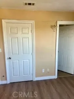 an empty room with wooden floor