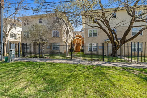 a view of a house with backyard and trees