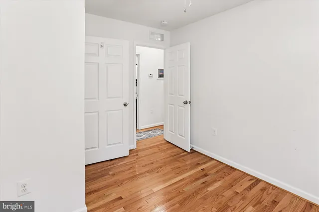 a view of a room with wooden floor and ceiling fan
