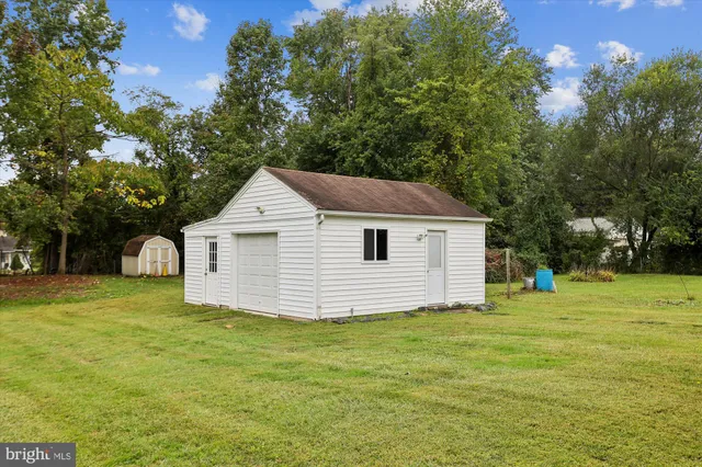 a bathroom with a toilet sink a mirror and shower