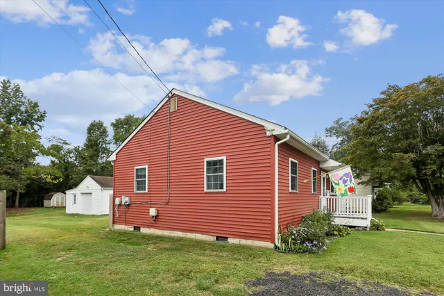 a front view of house with yard barbeque and outdoor seating