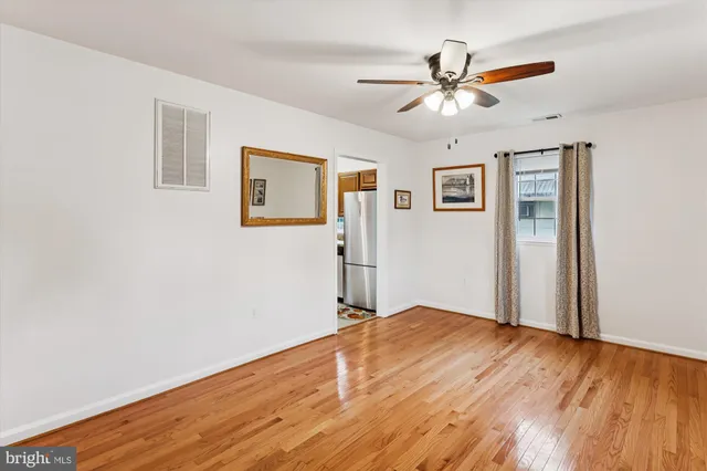 a view of an empty room with window and closet area