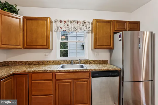 a kitchen with stainless steel appliances a stove a microwave and a refrigerator