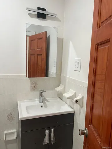 a bathroom with a sink toilet and mirror