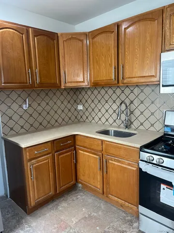 a kitchen with stainless steel appliances granite countertop a sink a stove and a microwave oven