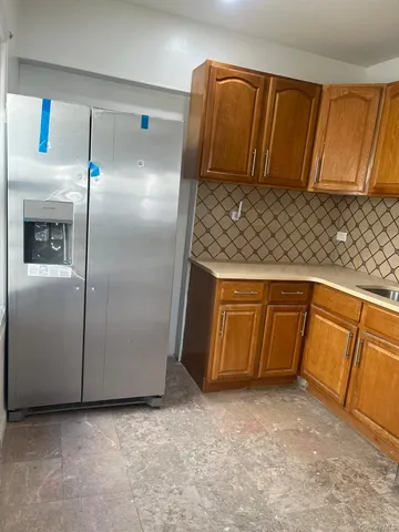 a kitchen with metallic refrigerator freezer and a dishwasher