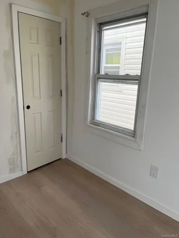 wooden floor and window in an empty room