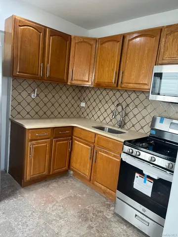a kitchen with wooden cabinets and a stove top oven
