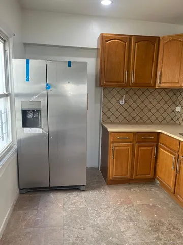 a kitchen with cabinets and refrigerator