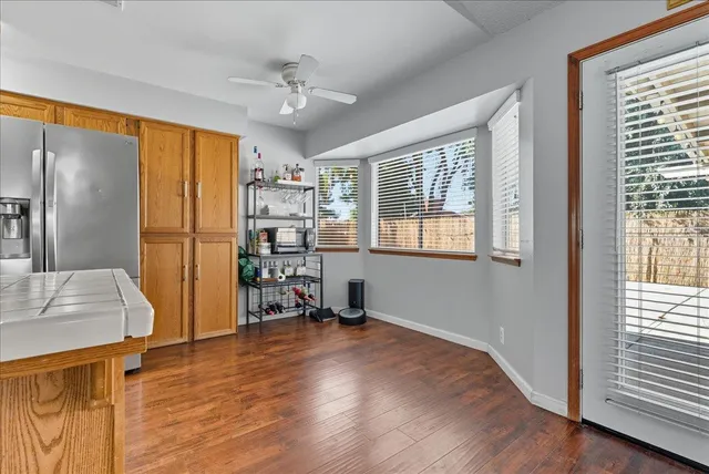 a view of a workspace with furniture and a window