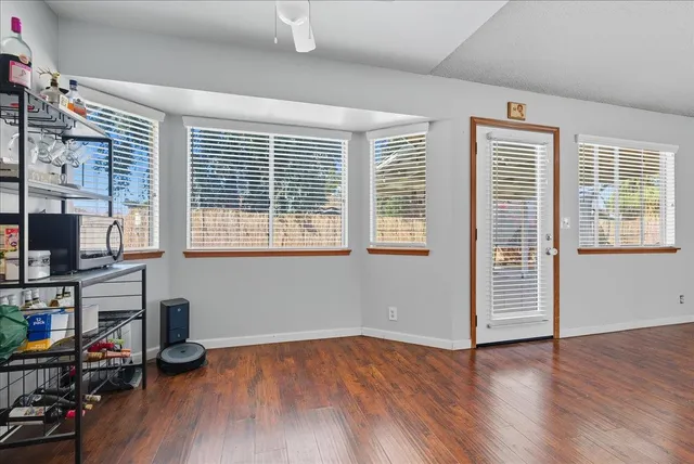 a view of a livingroom with hardwood floor and a window