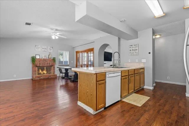 a kitchen with a sink cabinets and wooden floor