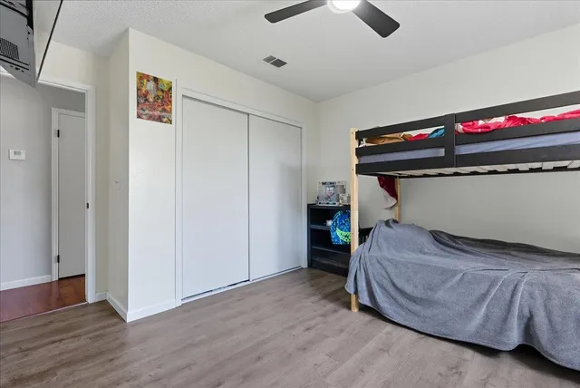 a bedroom with a bed and a ceiling fan