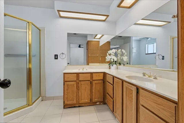 a spacious bathroom with a sink and a mirror