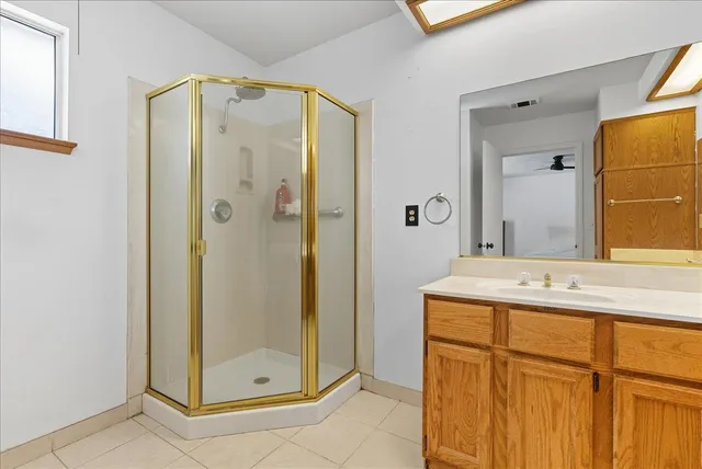 a bathroom with a shower and a sink mirror