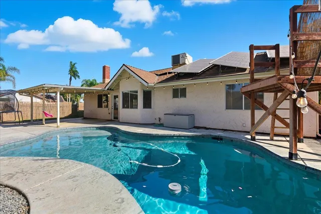an aerial view of a house with a yard and potted plants