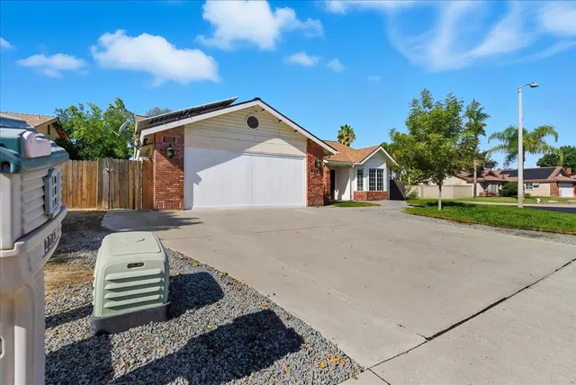 an aerial view of a house with garden space and street view