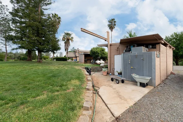 a view of a patio with furniture and a yard