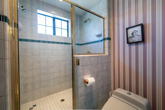 a bathroom with a shower and a sink
