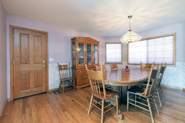 a view of a dining room with furniture window and wooden floor